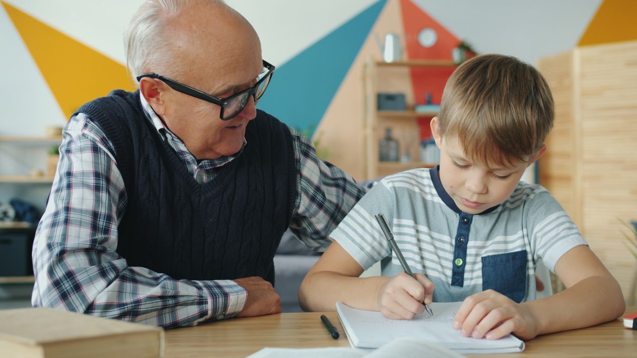 The Art of Drawing Readers In: Your attractive post title goes here Elderly man assisting young boy with school work at home.